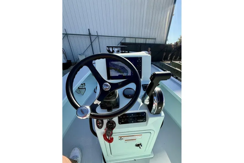 Slide: The Image of 2023 Hell's Bay Marquesa boat console with steering wheel and navigation system. - 9