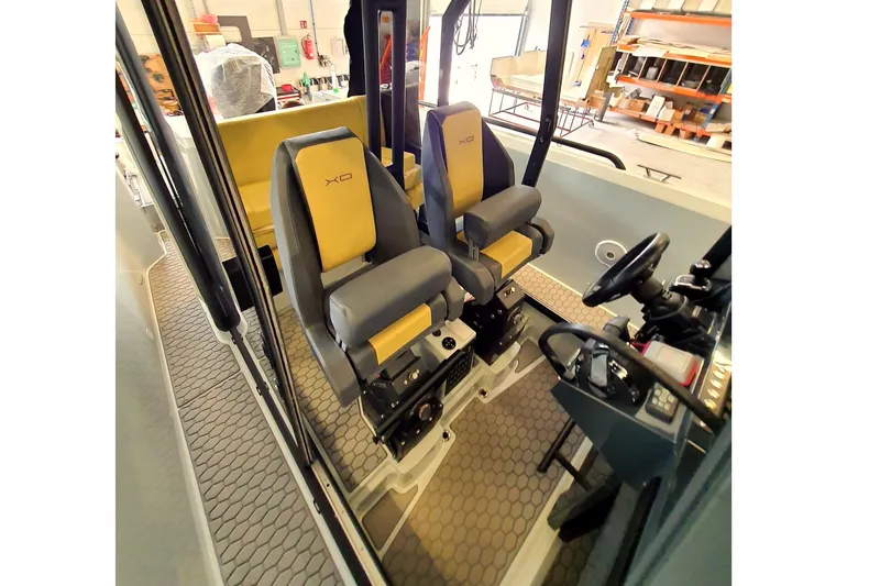 Slide: The Image of 2021 XO Boats DFNDR9 interior flooring with hexagonal pattern and beige seating. - 16