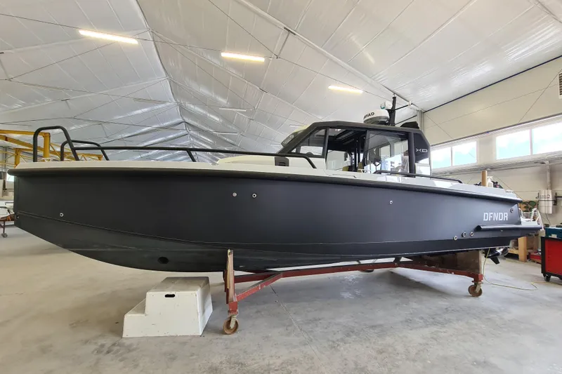 Slide: The Image of 2021 XO Boats DFNDR9 on tripe axle trailer - 2