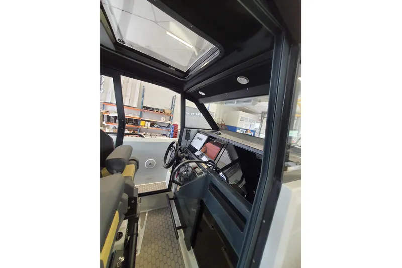 Slide: The Image of Interior of 2021 XO Boats DFNDR9, featuring compact sink and storage cabinets. - 21