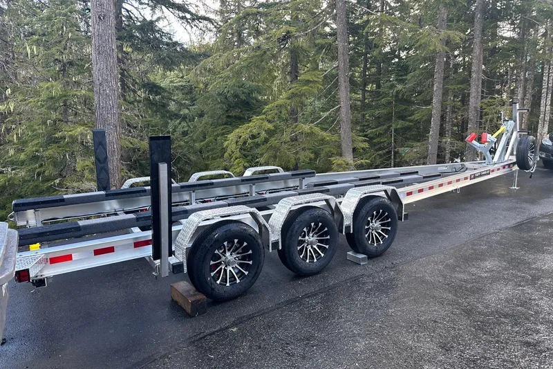 Slide: The Image of 2021 XO Boats DFNDR 9 with dual Mercury outboard engines in a showroom. - 38