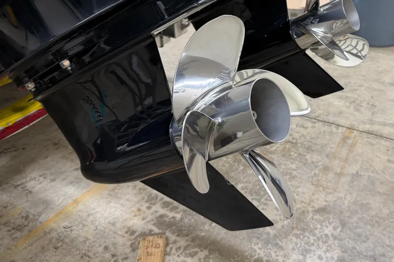 Slide: The Image of Close-up of XO Boats DFNDR 9 2021 dual propellers on a concrete floor. - 49