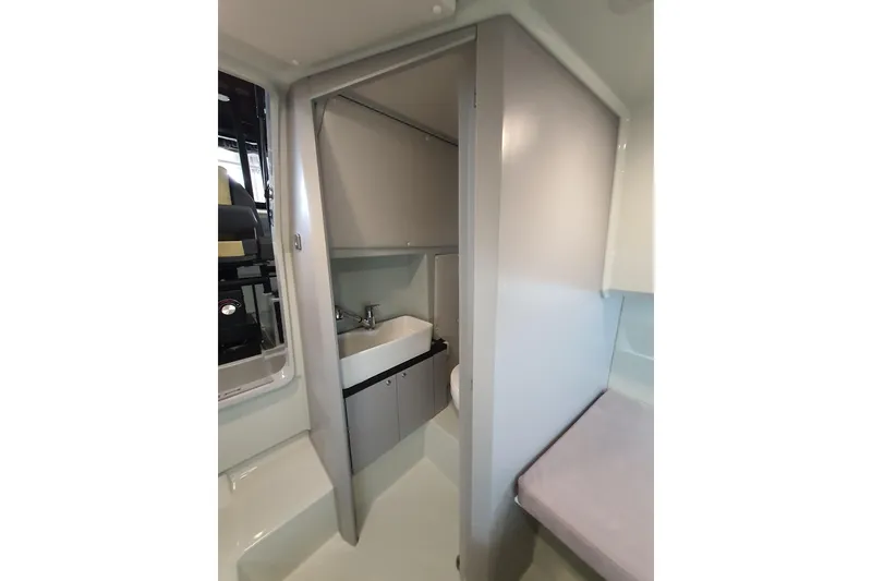 Slide: The Image of 2021 XO Boats DFNDR9 with Trailer in garage, featuring dual outboard motors. - 29