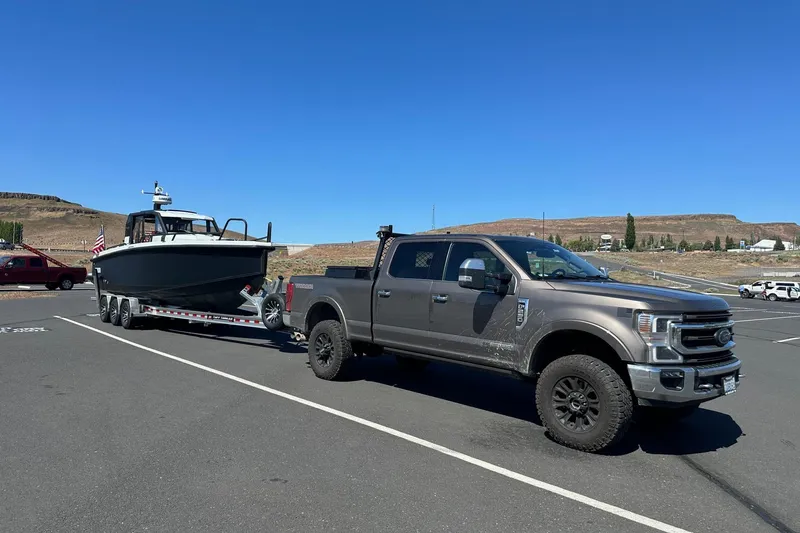 Slide: The Image of Steering wheel and dashboard of 2021 XO Boats DFNDR 9 with Simrad displays. - 36