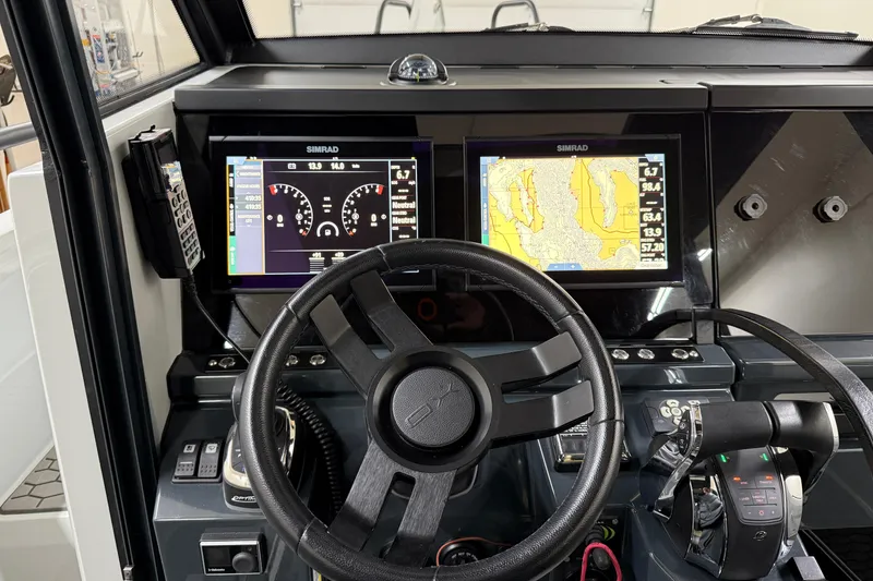 Slide: The Image of Cockpit of 2021 XO Boats DFNDR 9 with dual Simrad displays and steering wheel. - 45