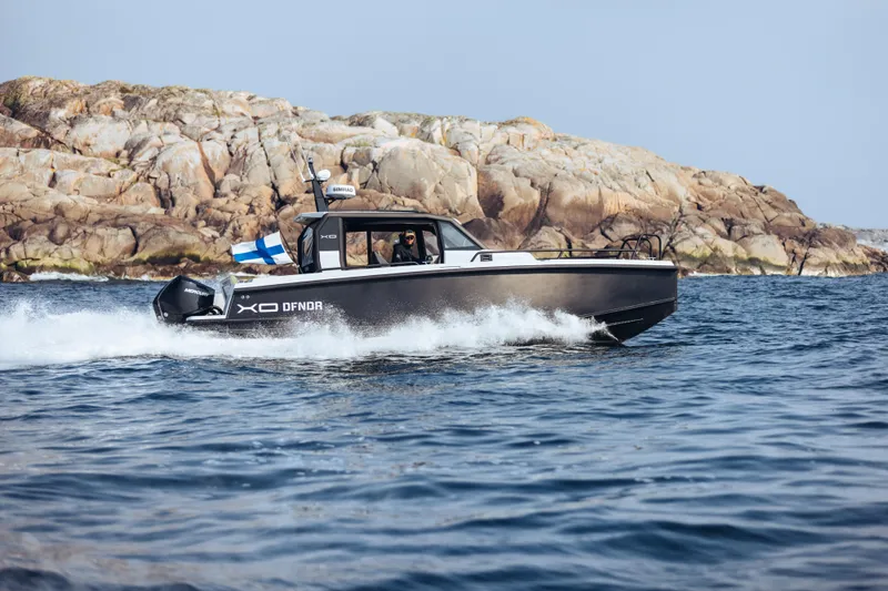 Slide: The Image of 2021 XO Boats DFNDR9 interior with hexagonal flooring in a workshop setting. - 5