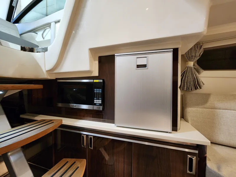Slide: The Image of Interior of Sea Ray Sundancer 320 yacht, kitchen with microwave and fridge. - 10