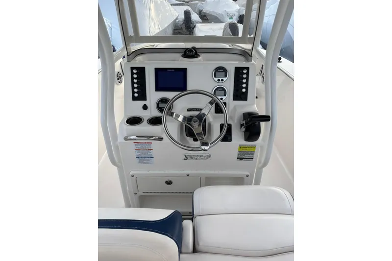 Slide: The Image of 2021 Robalo R200 Center Console boat dashboard with steering wheel and controls. - 12