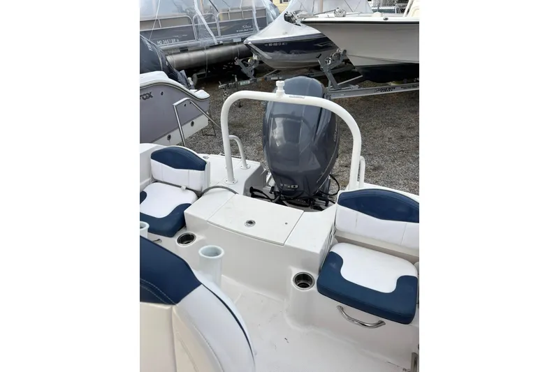 Slide: The Image of 2021 Robalo R200 Center Console boat interior with seating and engine view. - 14