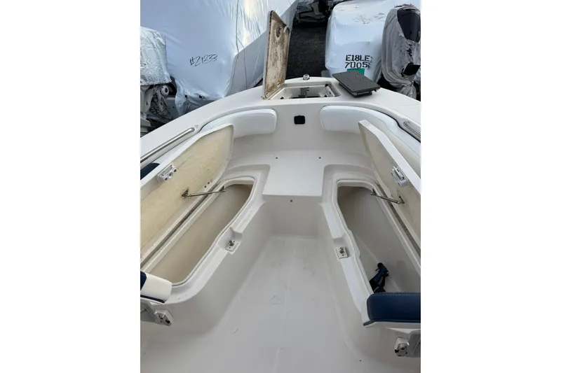 Slide: The Image of 2021 Robalo R200 Center Console boat interior with open storage compartments. - 15