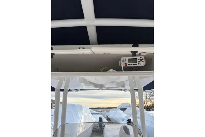 Slide: The Image of 2021 Robalo R200 Center Console boat with radio equipment under canopy. - 16