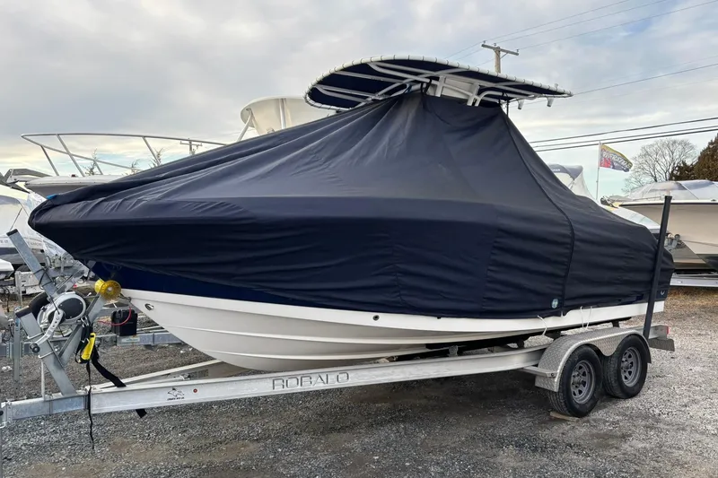 Slide: The Image of 2021 Robalo R200 Center Console boat covered on trailer, outdoor storage. - 17