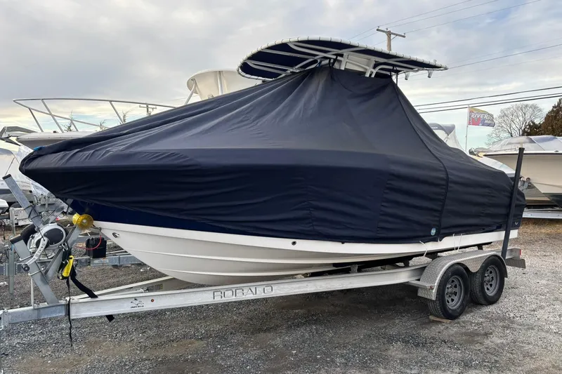 Slide: The Image of 2021 Robalo R200 Center Console boat covered on a trailer. - 18