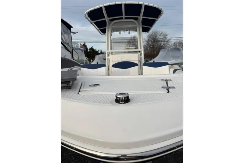 Slide: The Image of 2021 Robalo R200 Center Console boat with T-top and seating, docked outdoors. - 5