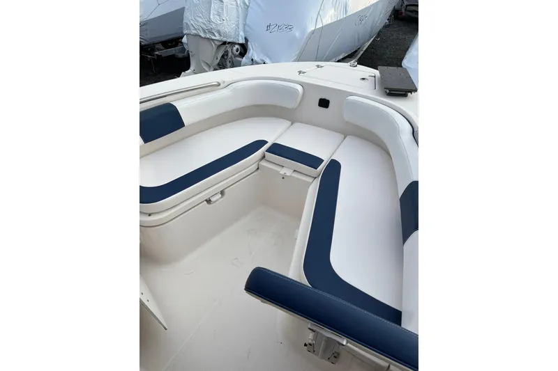 Slide: The Image of 2021 Robalo R200 Center Console boat with white and blue seating. - 8