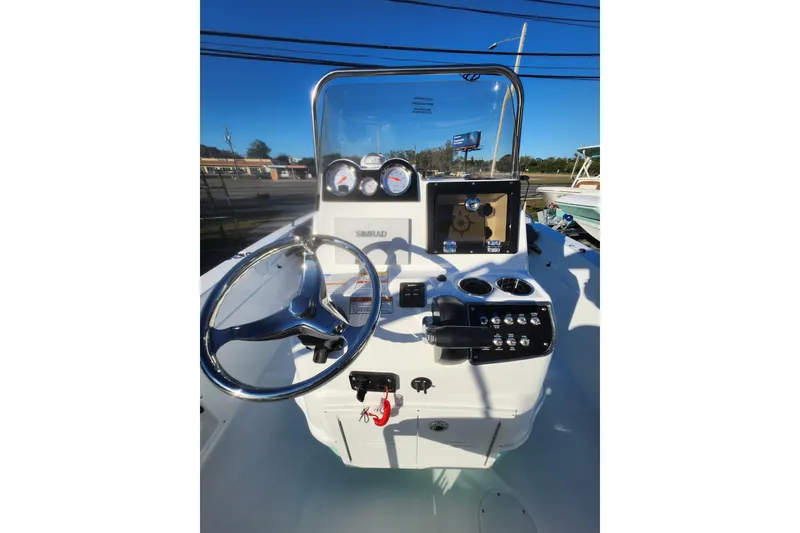 Slide: The Image of 2026 NauticStar 211 Hybrid boat dashboard with steering wheel and controls. - 5