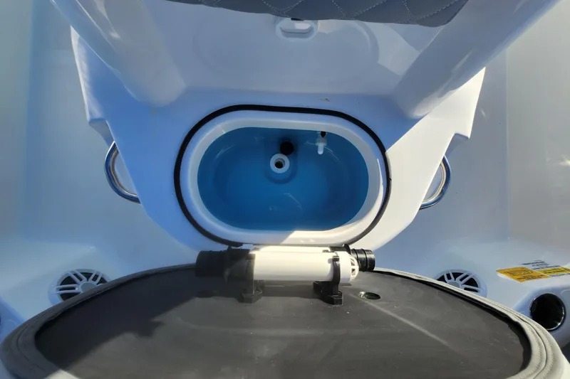 Slide: The Image of 2026 NauticStar 211 Hybrid boat interior with open storage compartment. - 7