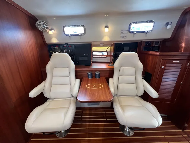 Slide: The Image of Interior of 2023 Island Packet 439 yacht with luxurious seating and wooden table. - 12