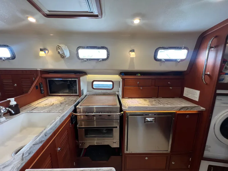 Slide: The Image of Interior view of Island Packet 439 yacht kitchen, 2023 model. - 19