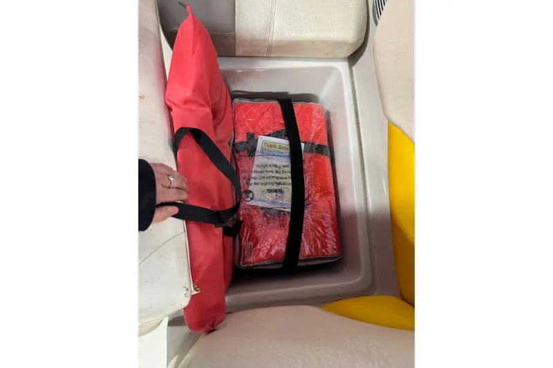 Slide: The Image of Storage compartment in 2009 Tahoe 215xi I/O boat with red safety equipment. - 10