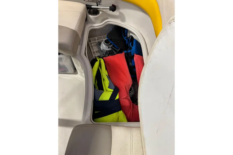 Slide: The Image of Storage compartment in 2009 Tahoe 215xi I/O boat with life jackets and gear. - 11