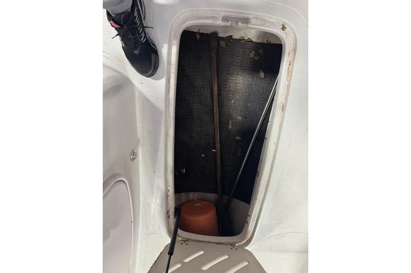 Slide: The Image of Open storage compartment in 2009 Tahoe 215xi I/O boat, showing interior details. - 12