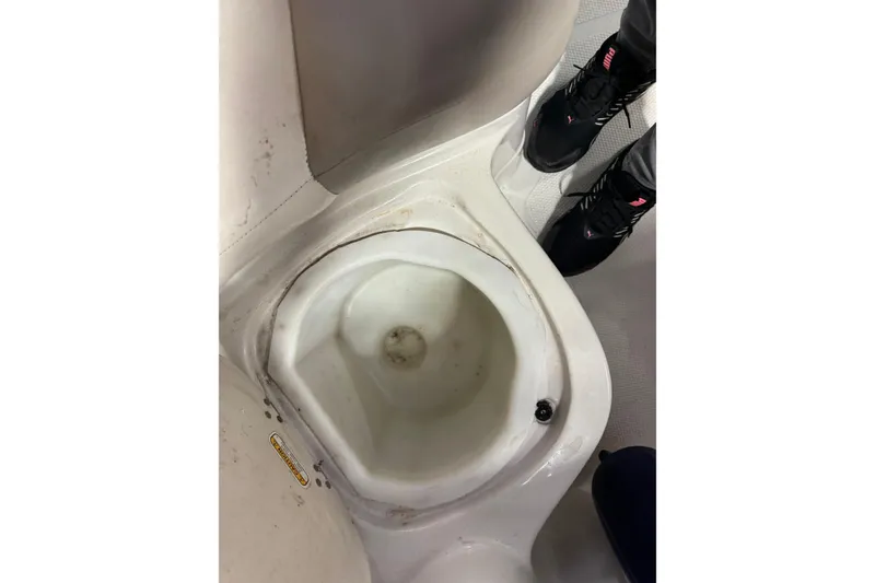 Slide: The Image of 2009 Tahoe 215xi I/O boat interior with built-in sink and footwear visible. - 13