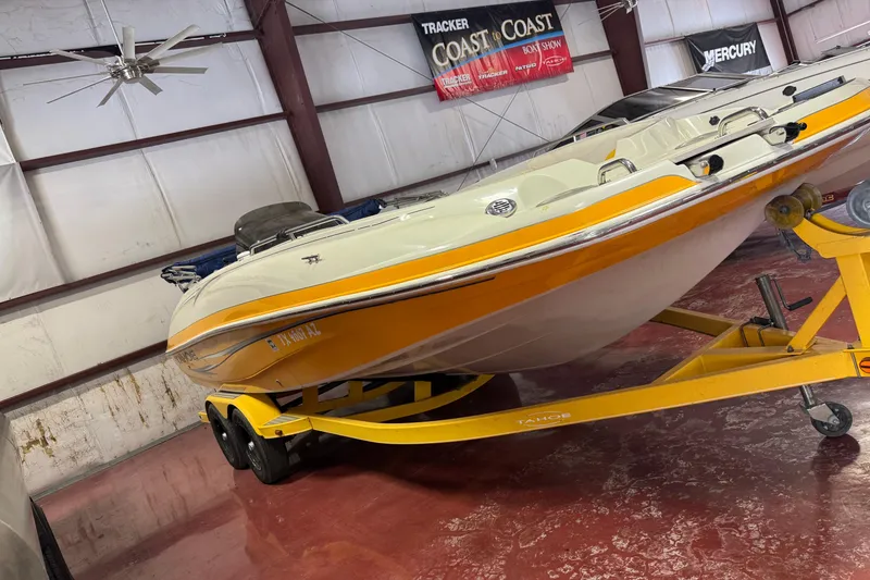 Slide: The Image of 2009 Tahoe 215xi I/O boat on yellow trailer in indoor storage facility. - 15