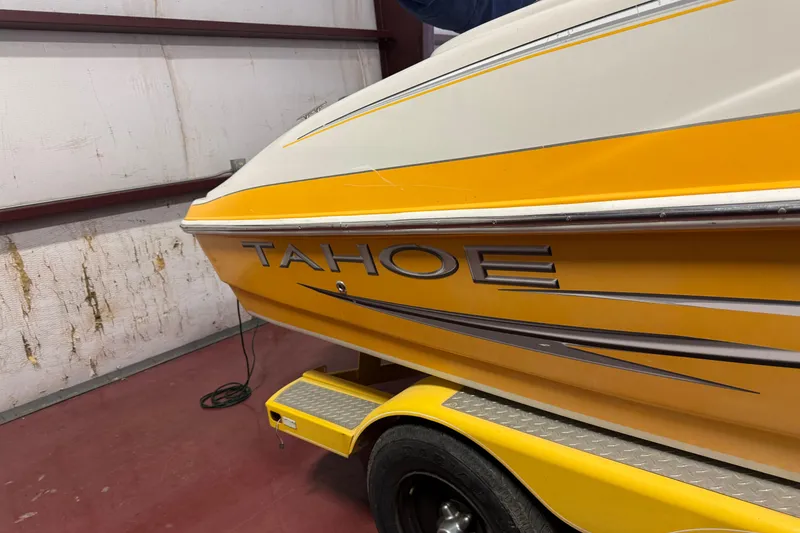 Slide: The Image of Yellow 2009 Tahoe 215xi I/O boat in a garage, side view. - 16