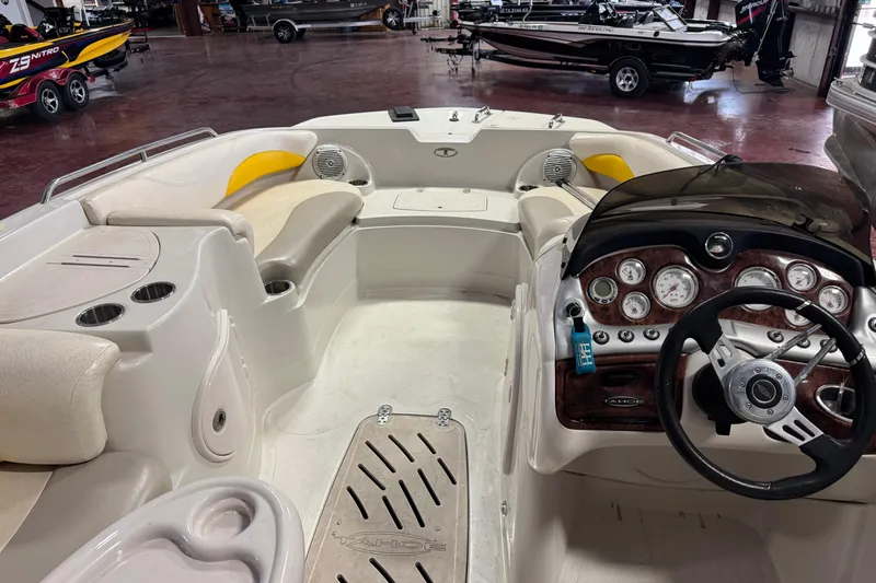 Slide: The Image of 2009 Tahoe 215xi I/O boat interior with steering wheel, seating, and dashboard in showroom. - 3