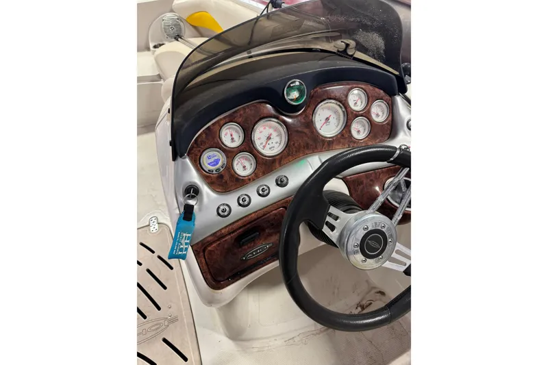 Slide: The Image of 2009 Tahoe 215xi I/O boat dashboard with gauges and steering wheel. - 4