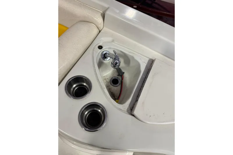 Slide: The Image of 2009 Tahoe 215xi I/O boat interior with cup holders and faucet. - 6