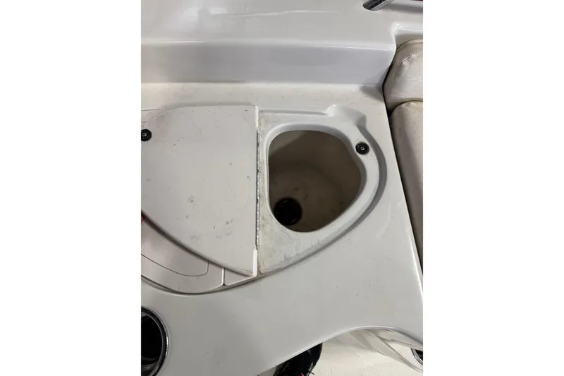 Slide: The Image of 2009 Tahoe 215xi I/O boat interior with storage compartment and cup holder. - 7