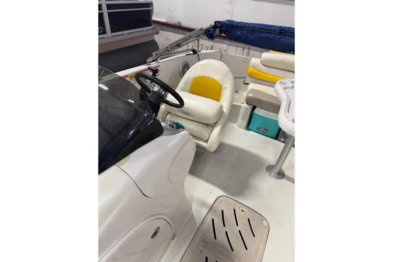 Slide: The Image of 2009 Tahoe 215xi I/O boat interior with steering wheel and seating area. - 8