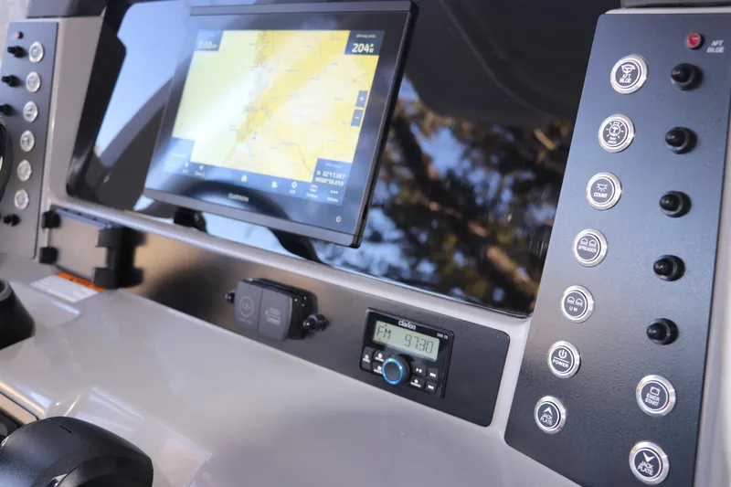 Slide: The Image of Dashboard of 2026 Robalo 246 Cayman with navigation display and control buttons. - 19