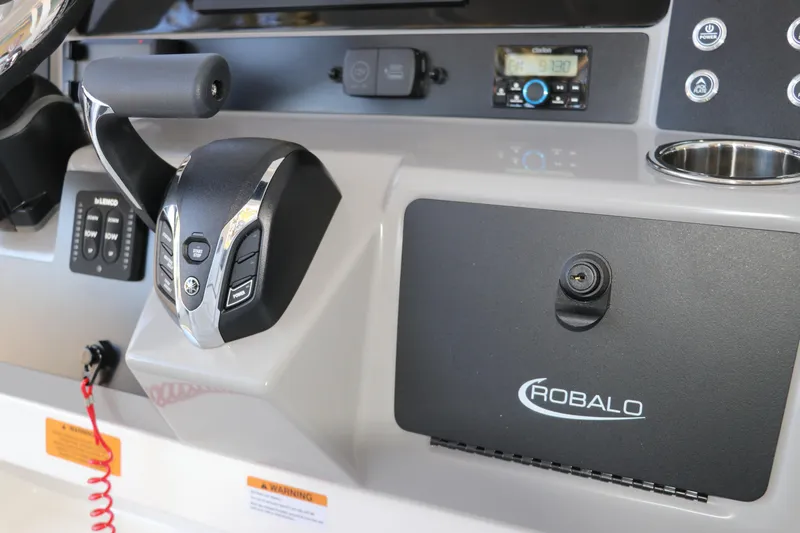 Slide: The Image of Control panel of 2026 Robalo 246 Cayman boat with throttle and storage compartment. - 20