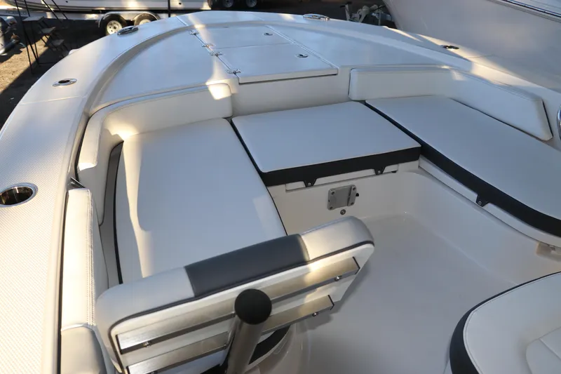 Slide: The Image of 2026 Robalo 246 Cayman boat interior with cushioned seating and storage compartments. - 24