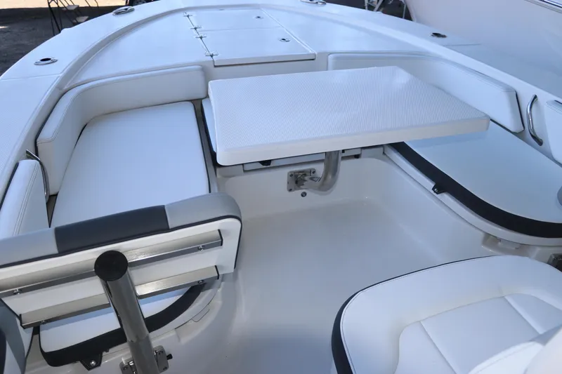 Slide: The Image of 2026 Robalo 246 Cayman boat interior with white seating and table. - 25