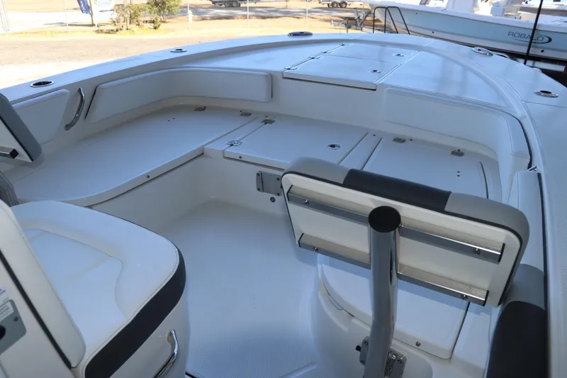 Slide: The Image of 2026 Robalo 246 Cayman boat interior with seating and storage compartments. - 26