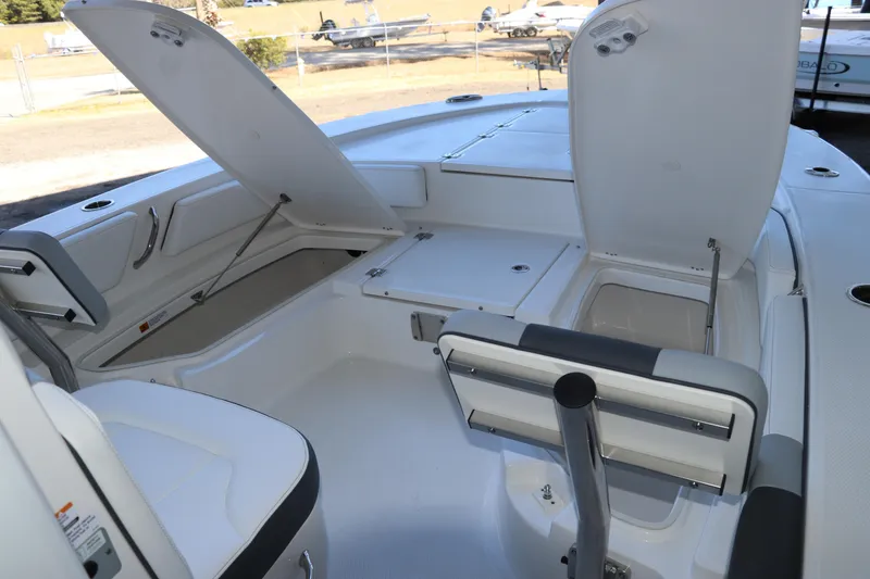 Slide: The Image of 2026 Robalo 246 Cayman boat interior with open storage compartments and seating. - 27