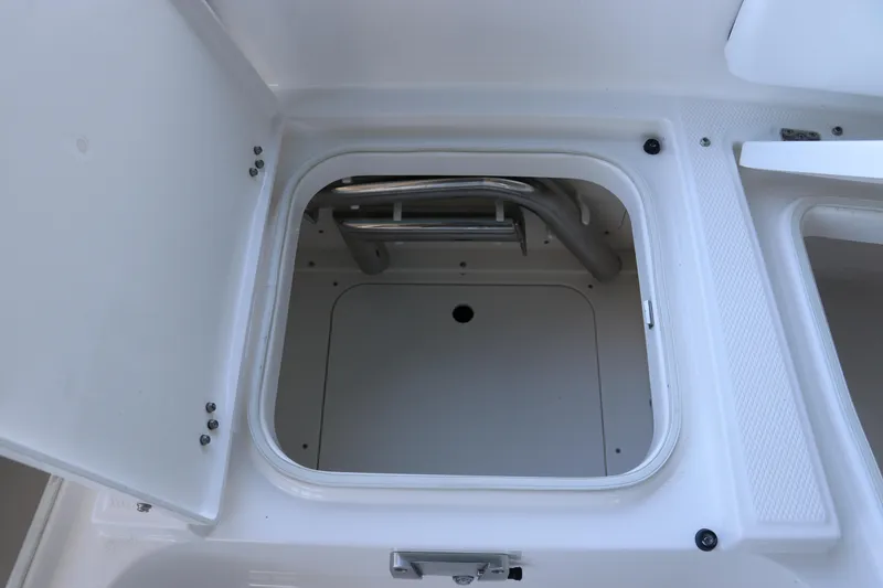 Slide: The Image of Open storage compartment on 2026 Robalo 246 Cayman boat. - 29