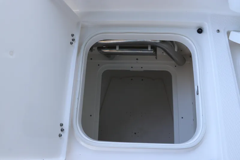 Slide: The Image of Open storage compartment on 2026 Robalo 246 Cayman boat. - 30