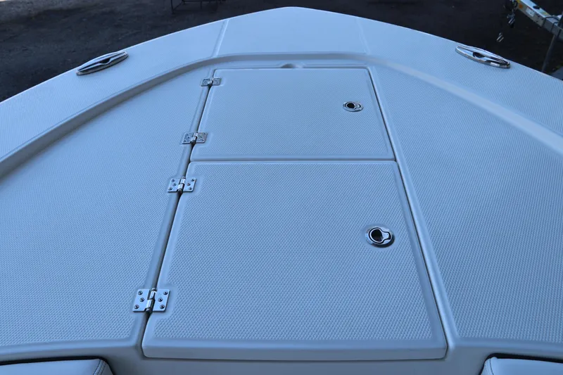 Slide: The Image of 2026 Robalo 246 Cayman boat deck with storage compartments and stainless steel hardware. - 32