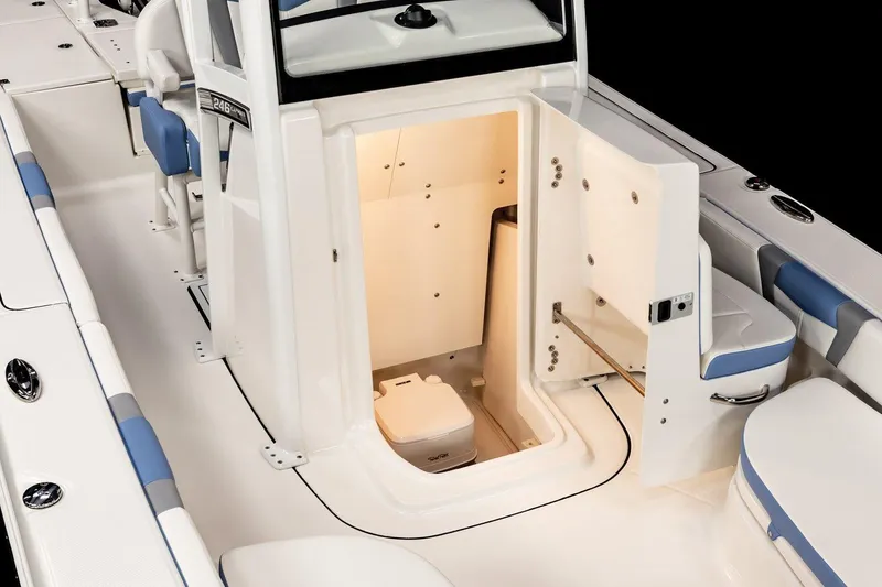 Slide: The Image of Manufacturer Provided Image: 2025 Robalo 246 Cayman boat with open storage compartments, white and blue interior. - 9