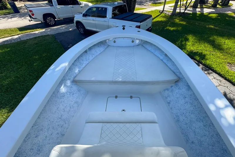 Slide: The Image of 1972 Cuda Craft Open Fisherman boat interior with white seating and textured flooring. - 28