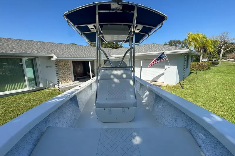 Slide: The Image of 1972 Cuda Craft Open Fisherman boat with T-top, parked in front of a house. - 47
