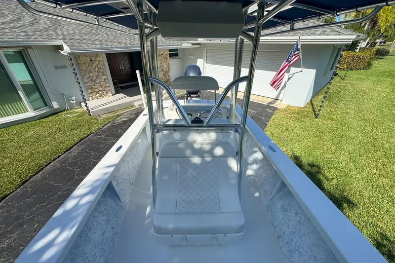 Slide: The Image of 1972 Cuda Craft Open Fisherman boat parked in a driveway, American flag visible. - 49