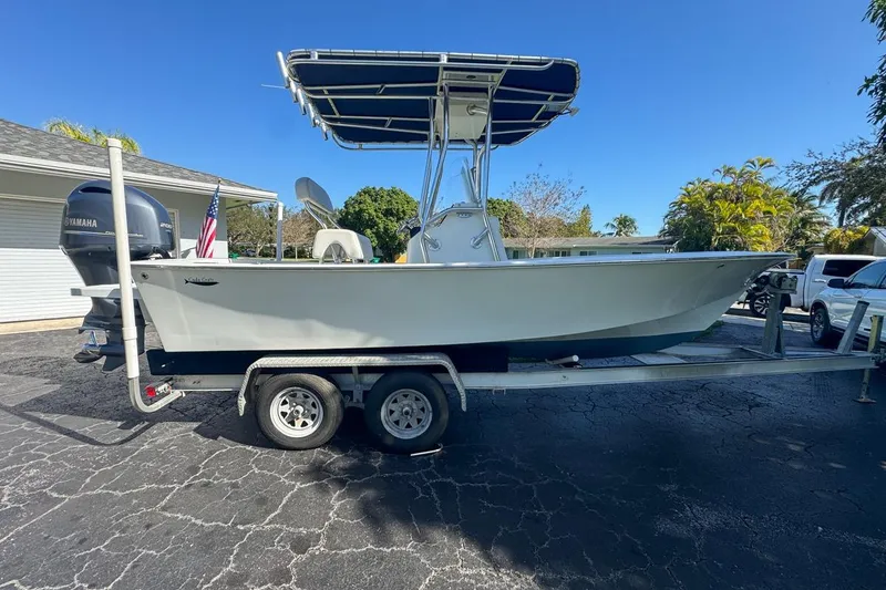 Slide: The Image of 1972 Cuda Craft Open Fisherman boat on trailer, parked outdoors under clear blue sky. - 5