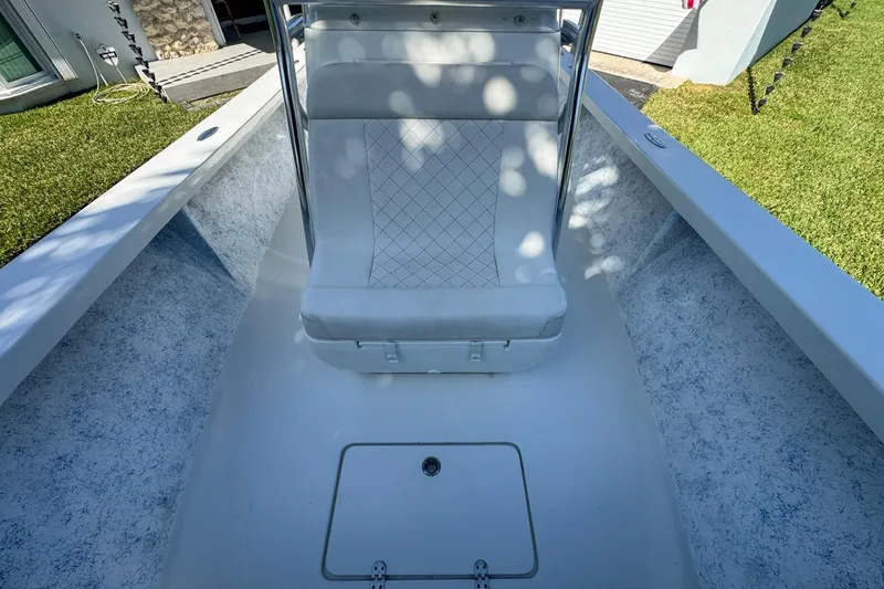 Slide: The Image of 1972 Cuda Craft Open Fisherman boat interior with white seating and storage compartment. - 52