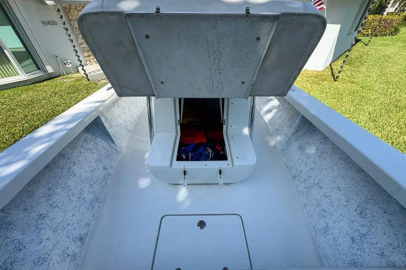 Slide: The Image of 1972 Cuda Craft Open Fisherman boat with open storage compartment, docked on grass. - 53